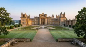Alt text for image 3: A wide, photorealistic view of Blenheim Palace in Oxfordshire, the birthplace of Winston Churchill, featuring the formal gardens and grand facade.