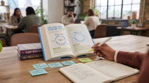 A focused business owner highlighting key insights in an introductory entrepreneurship guide.