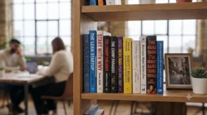 A close-up shot of a bookshelf featuring a curated collection of foundational entrepreneurship titles.