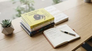 An enterprise executive taking notes while reading a best-selling corporate management guide.